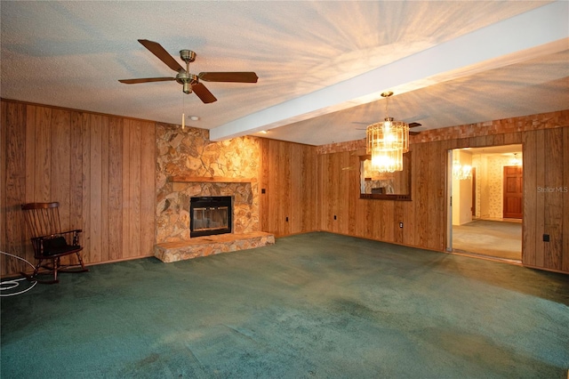 unfurnished living room featuring dark carpet, a stone fireplace, and wooden walls