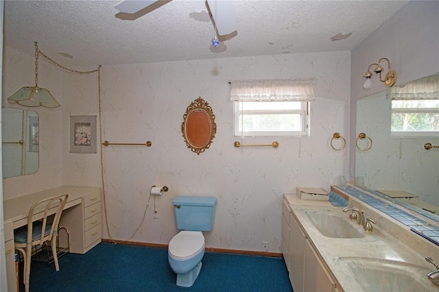 bathroom with ceiling fan, a wealth of natural light, toilet, and a textured ceiling