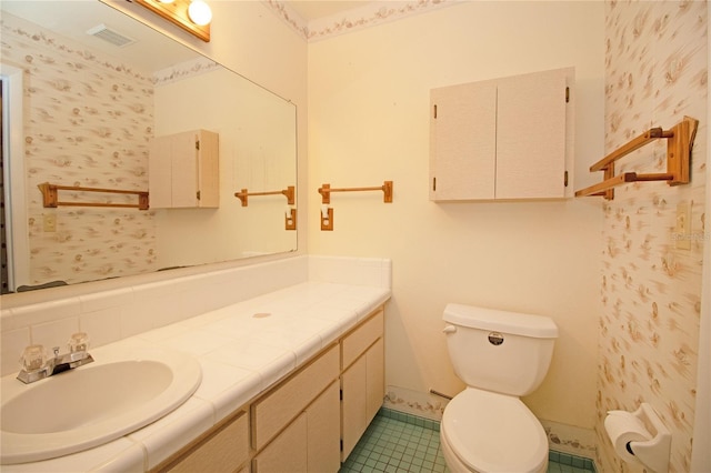 bathroom with vanity, tile patterned floors, and toilet