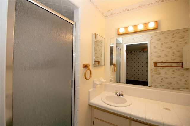 bathroom featuring vanity and a shower with shower door