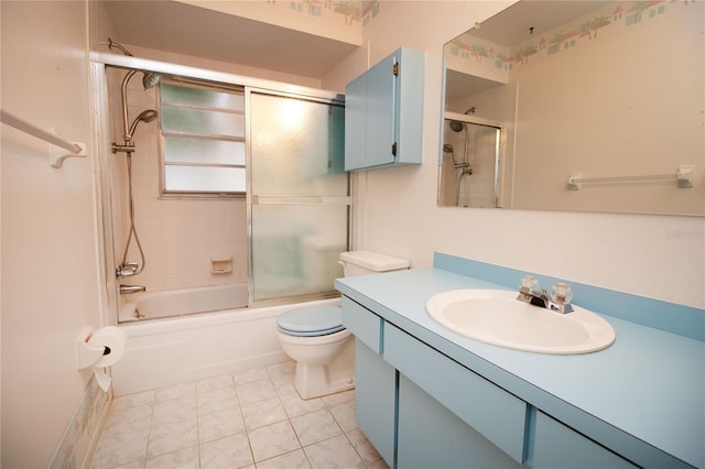 full bathroom featuring vanity, combined bath / shower with glass door, tile patterned floors, and toilet