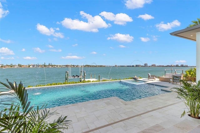 view of pool with a water view, pool water feature, and a patio area