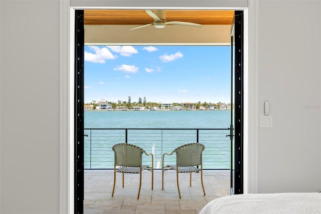 balcony with a water view and ceiling fan