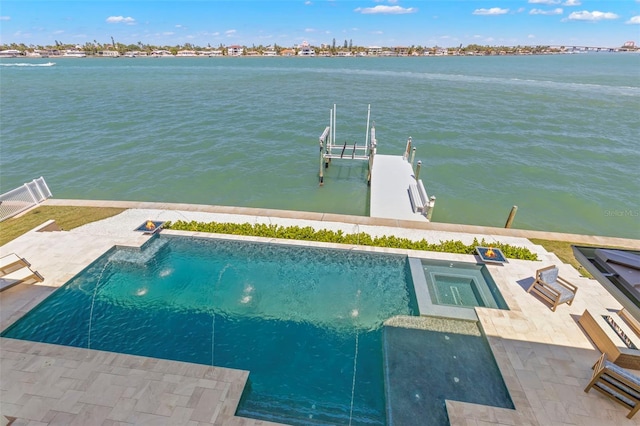 exterior space featuring pool water feature, a water view, and a swimming pool with hot tub