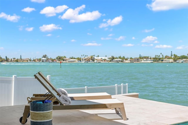 dock area with a water view and a patio