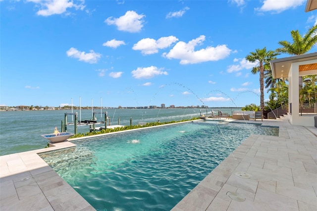 view of pool with a dock, a water view, pool water feature, and a patio