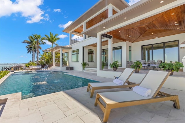 view of pool with pool water feature and a patio area