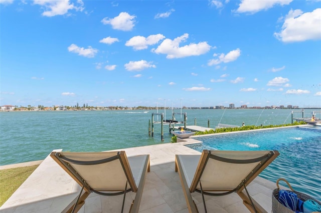 view of swimming pool with pool water feature, a boat dock, and a water view