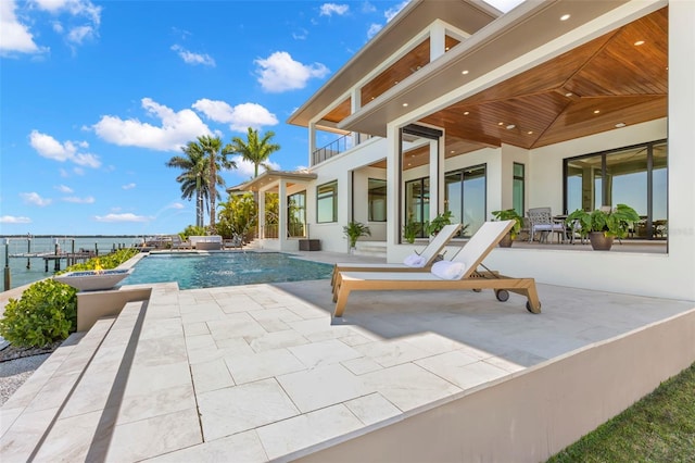 view of swimming pool featuring a patio, a water view, and pool water feature