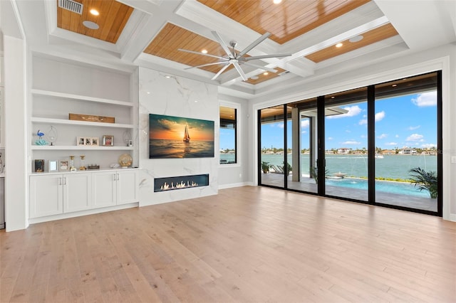 unfurnished living room featuring a fireplace, built in features, coffered ceiling, and wood ceiling