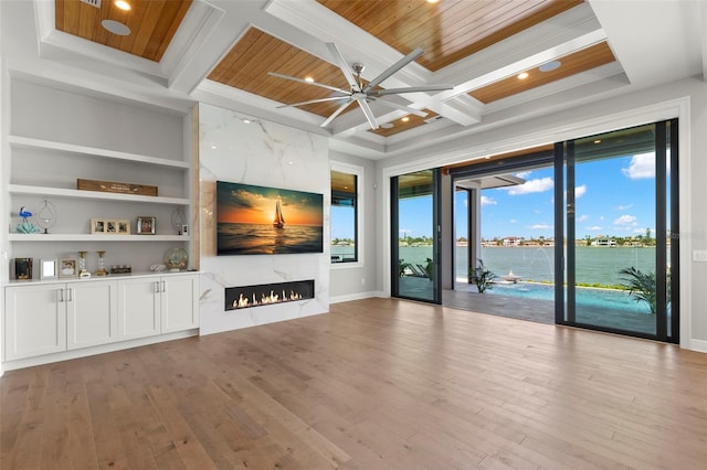 unfurnished living room featuring a high end fireplace, wooden ceiling, coffered ceiling, beam ceiling, and built in features