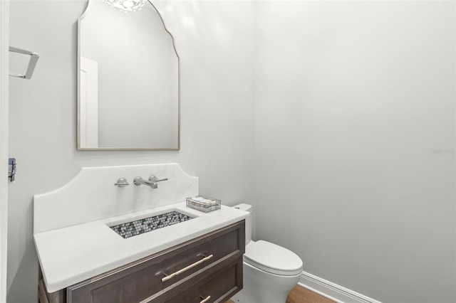 bathroom featuring toilet and vanity