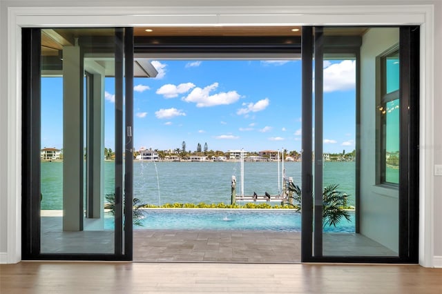 entryway featuring a water view and hardwood / wood-style floors