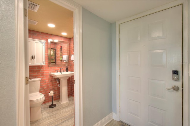 bathroom featuring hardwood / wood-style floors and toilet