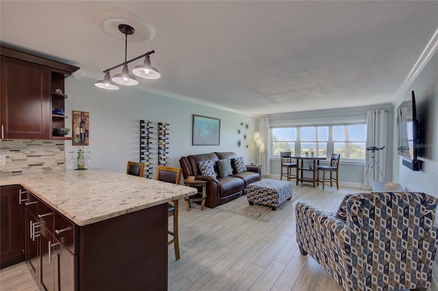 living room featuring crown molding and light hardwood / wood-style flooring