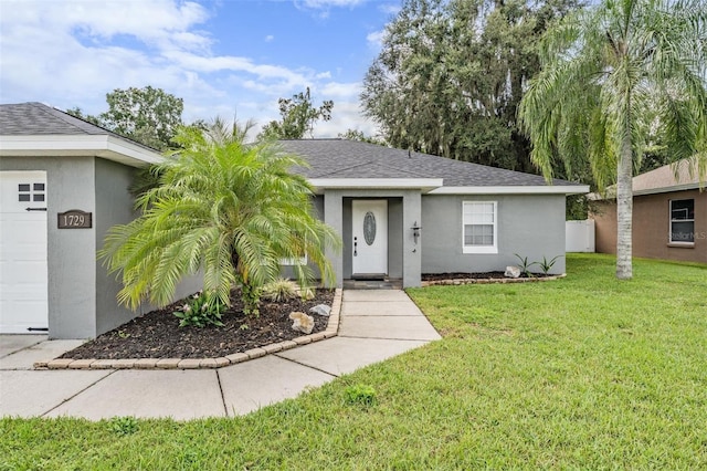 single story home featuring a front lawn, a shingled roof, and stucco siding