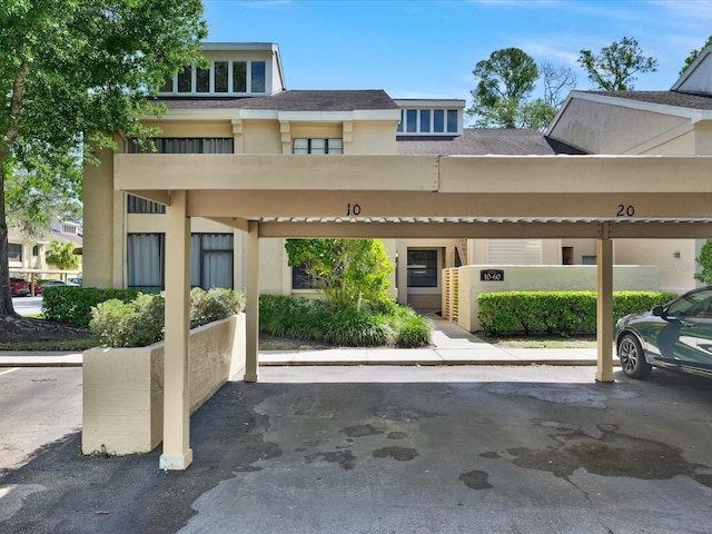 view of front of property featuring a carport