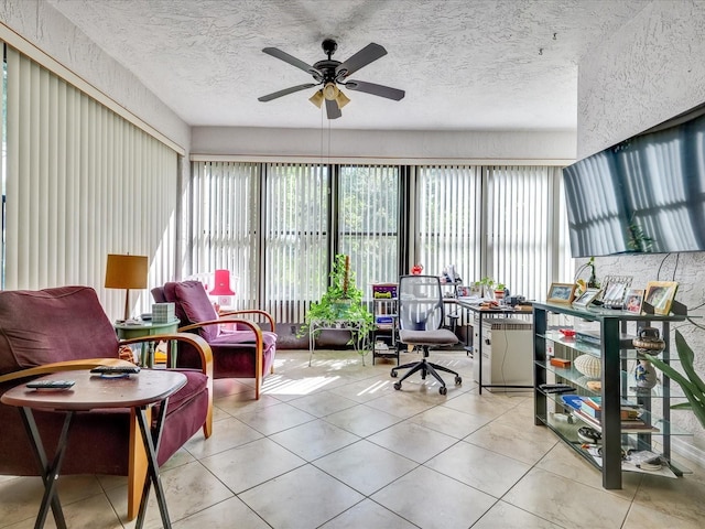 interior space featuring ceiling fan, a textured ceiling, and light tile flooring