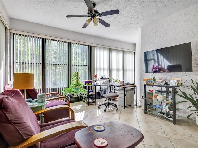 living room featuring ceiling fan, a textured ceiling, light tile floors, and plenty of natural light