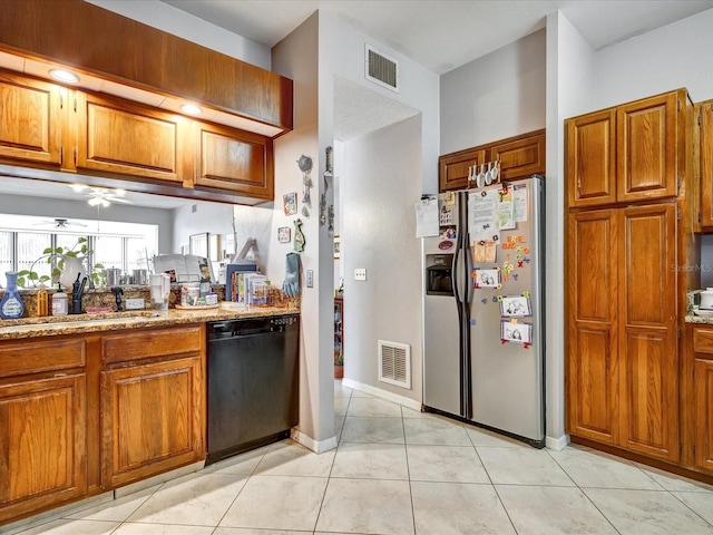 kitchen with light tile floors, dishwasher, sink, stainless steel fridge with ice dispenser, and light stone countertops