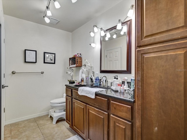 bathroom with rail lighting, tile floors, toilet, and vanity