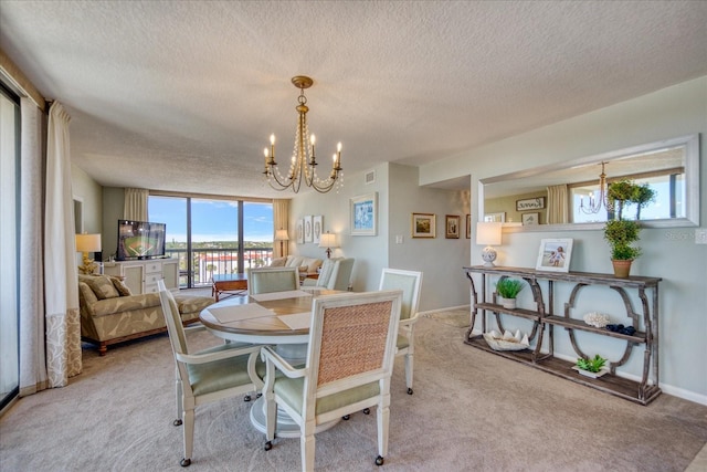 carpeted dining area with an inviting chandelier and a textured ceiling