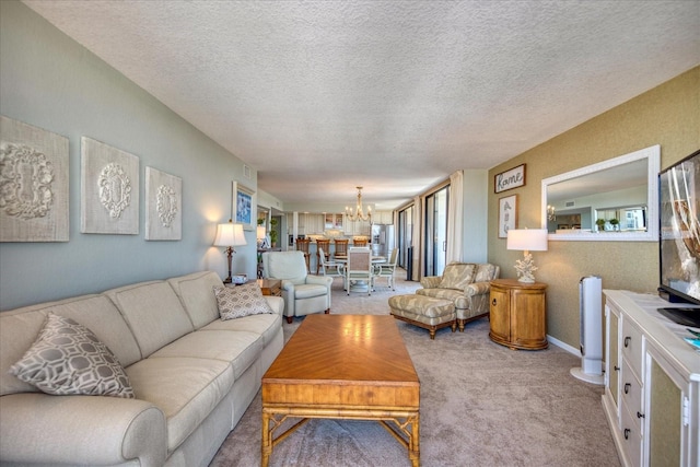 carpeted living room featuring a textured ceiling and a chandelier