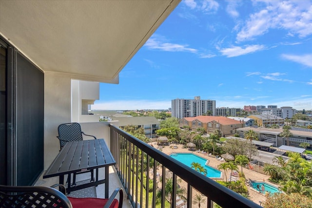 balcony featuring a community pool