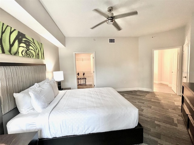 bedroom featuring hardwood / wood-style floors, ensuite bath, and ceiling fan