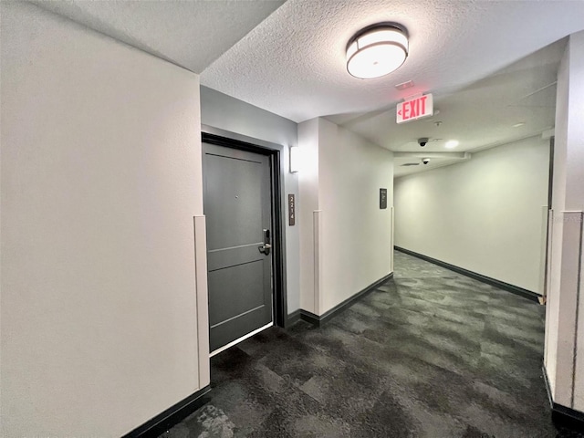 hall with a textured ceiling