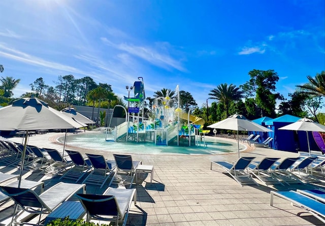 view of swimming pool featuring pool water feature and a patio