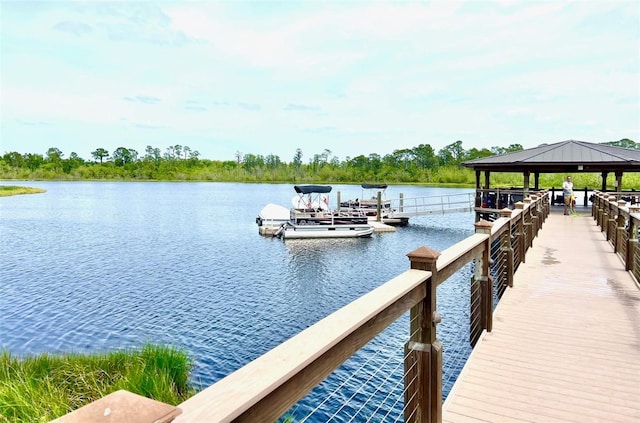 view of dock with a gazebo and a water view