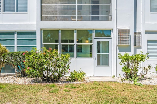 doorway to property with a yard