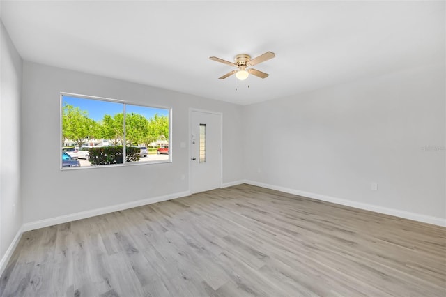 empty room featuring ceiling fan and light hardwood / wood-style flooring