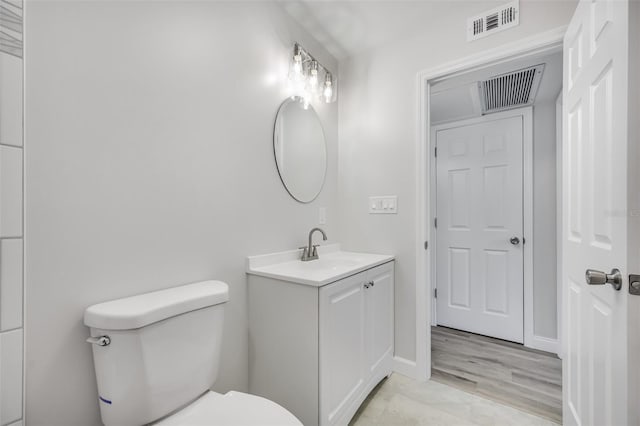 bathroom with toilet and vanity