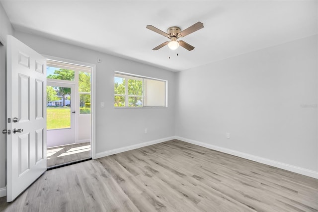 empty room with ceiling fan and light wood-type flooring