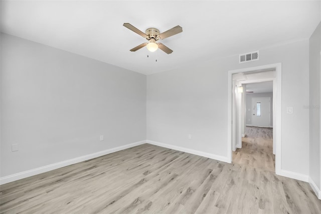 empty room with ceiling fan and light hardwood / wood-style floors