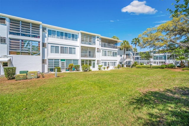 rear view of property with a lawn