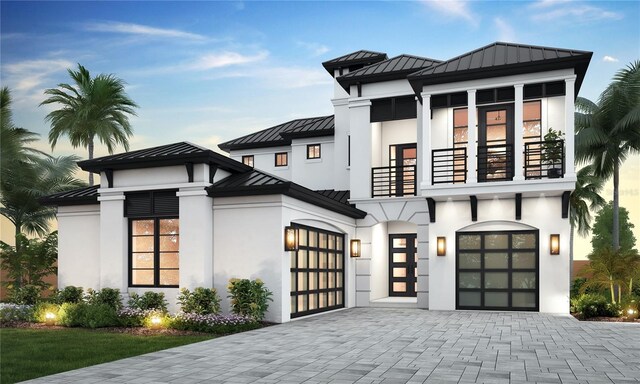 view of front of home with a balcony and a garage