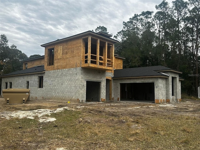 back of property featuring a garage