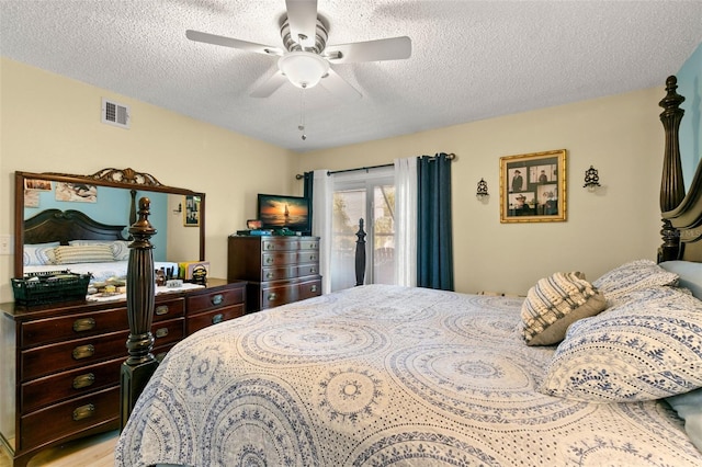 bedroom featuring access to exterior, ceiling fan, and a textured ceiling