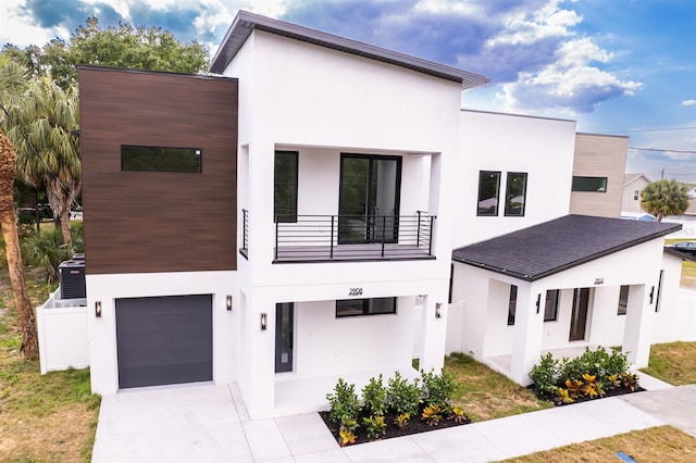 contemporary home featuring a garage and a balcony