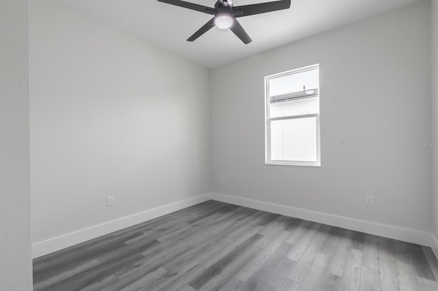 spare room featuring hardwood / wood-style floors and ceiling fan