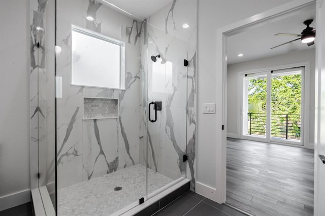 bathroom with tile flooring, ceiling fan, and a shower with shower door