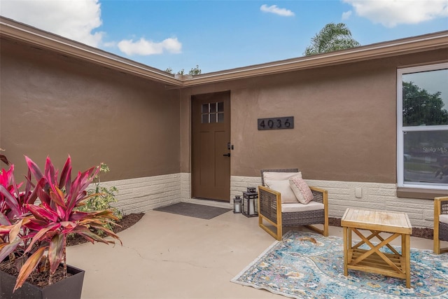 entrance to property with a patio