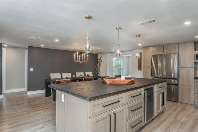 kitchen featuring wine cooler, light hardwood / wood-style flooring, stainless steel refrigerator, and an inviting chandelier