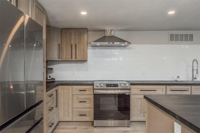 kitchen featuring wall chimney exhaust hood, light hardwood / wood-style flooring, stainless steel appliances, sink, and tasteful backsplash