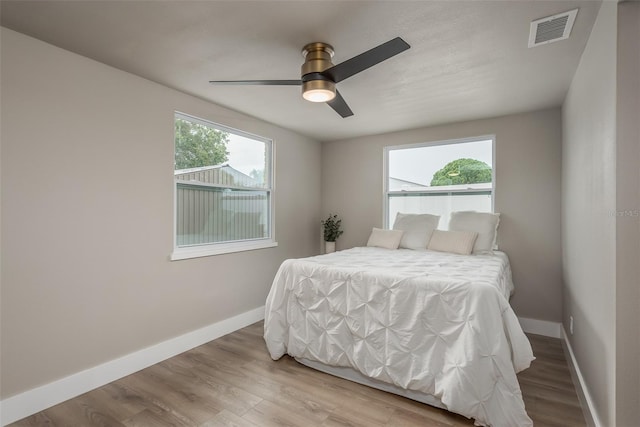 bedroom with ceiling fan and light wood-type flooring