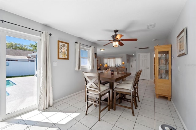 tiled dining area with ceiling fan