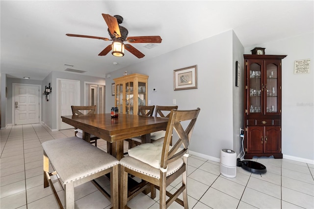 tiled dining room featuring ceiling fan